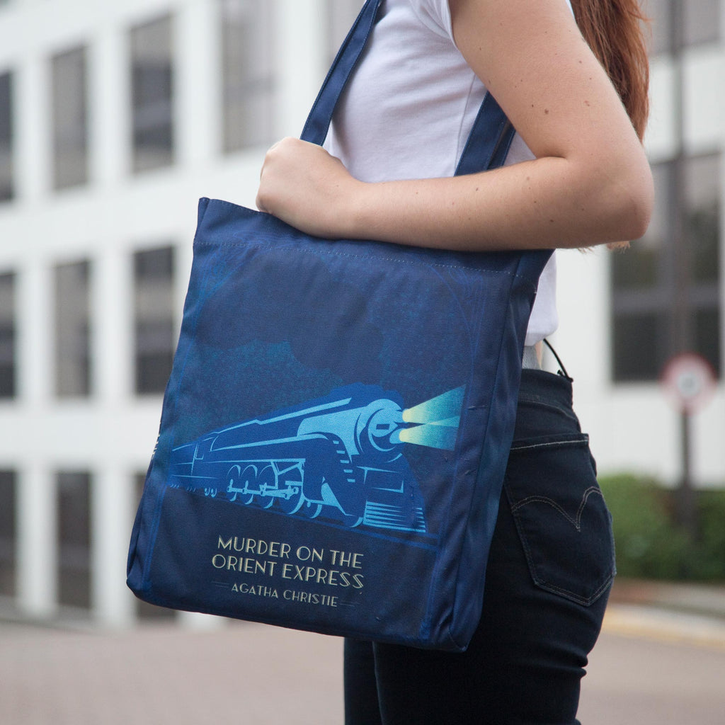 The Murder on the Orient Express Blue Tote Bag by Agatha Christie featuring Steam Train design, by Well Read Co. - Model with bag