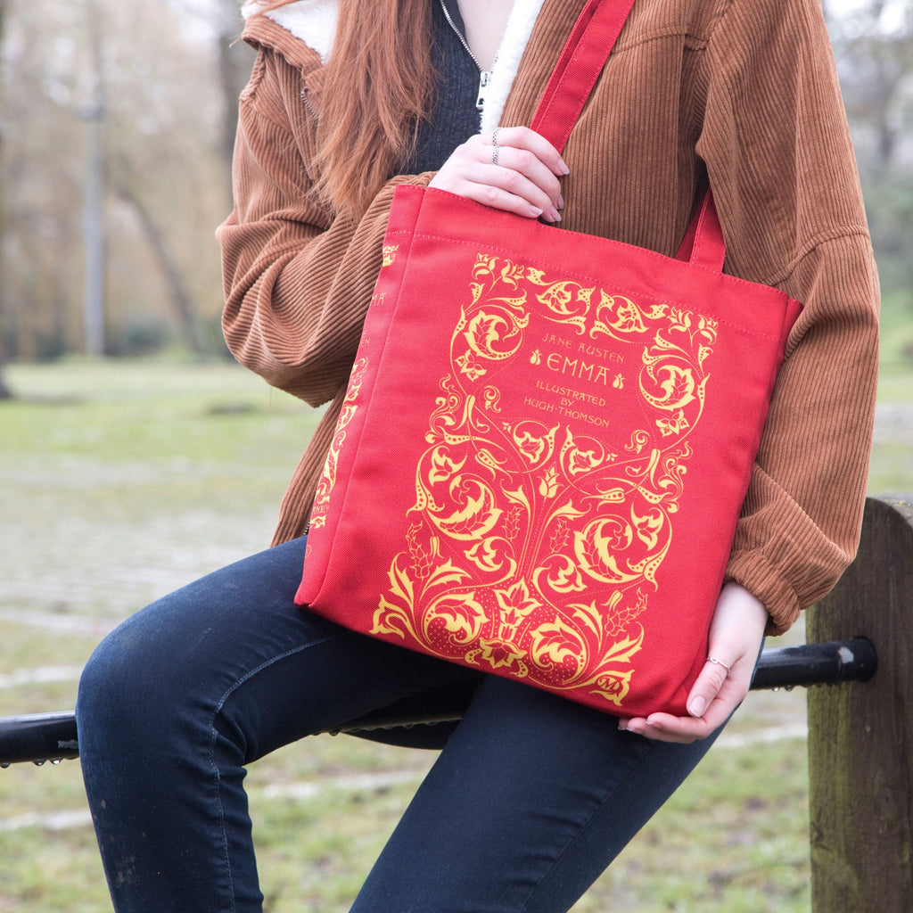 Emma Red Tote Bag by Jane Austen featuring Gold Leaf design, by Well Read Co. - model sitting